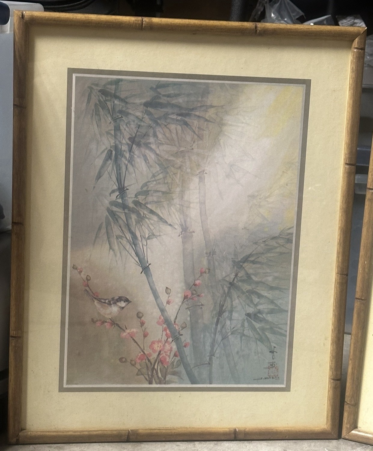 This framed artwork Is a Chinese-style bamboo and bird painting.
