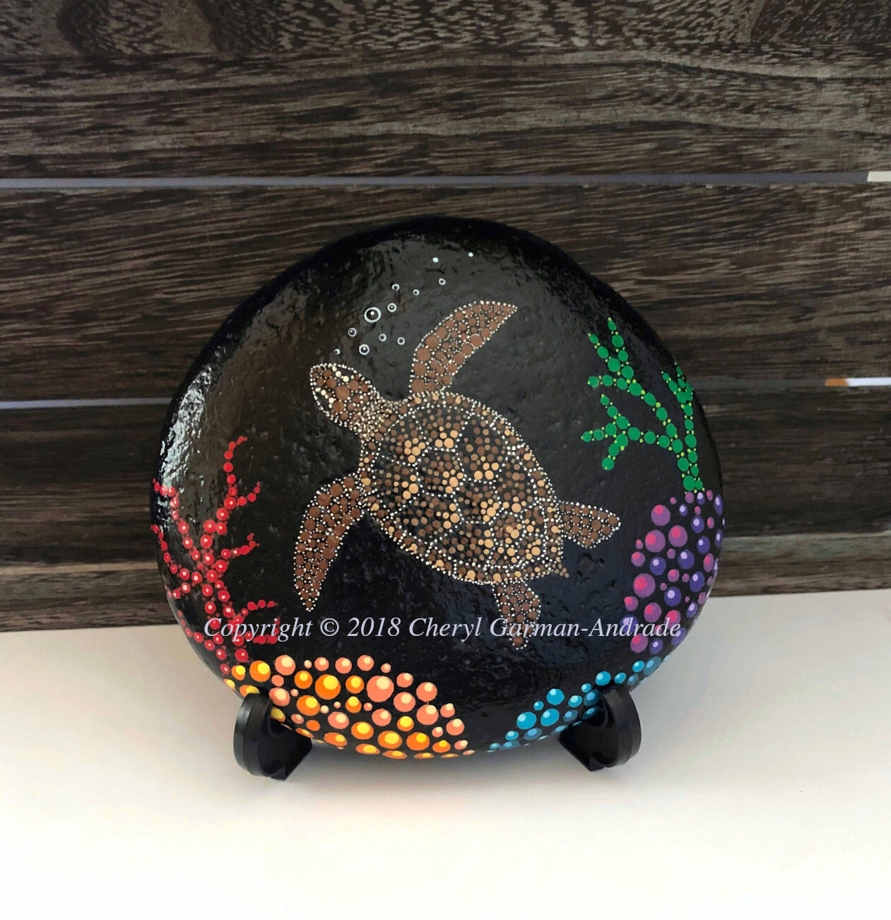 Sea Turtle and Reef Pointillism Painted River Stone by Cheryl Garman-Andrade.