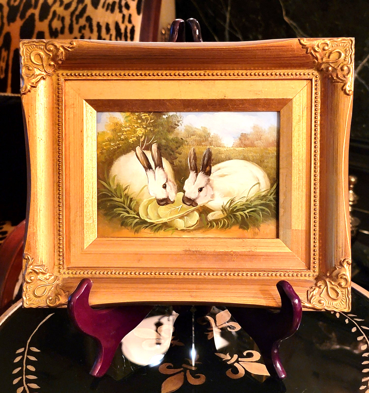 GILT FRAMED PAINTING ON BOARD OF A PAIR OF WHITE RABBITS EATING LETTUCE, 11.5»L