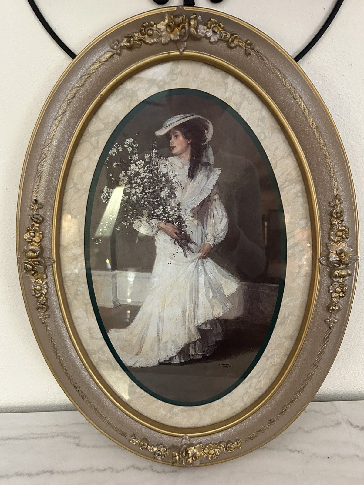 Elegant vintage oval-framed portrait featuring a Victorian-style lady