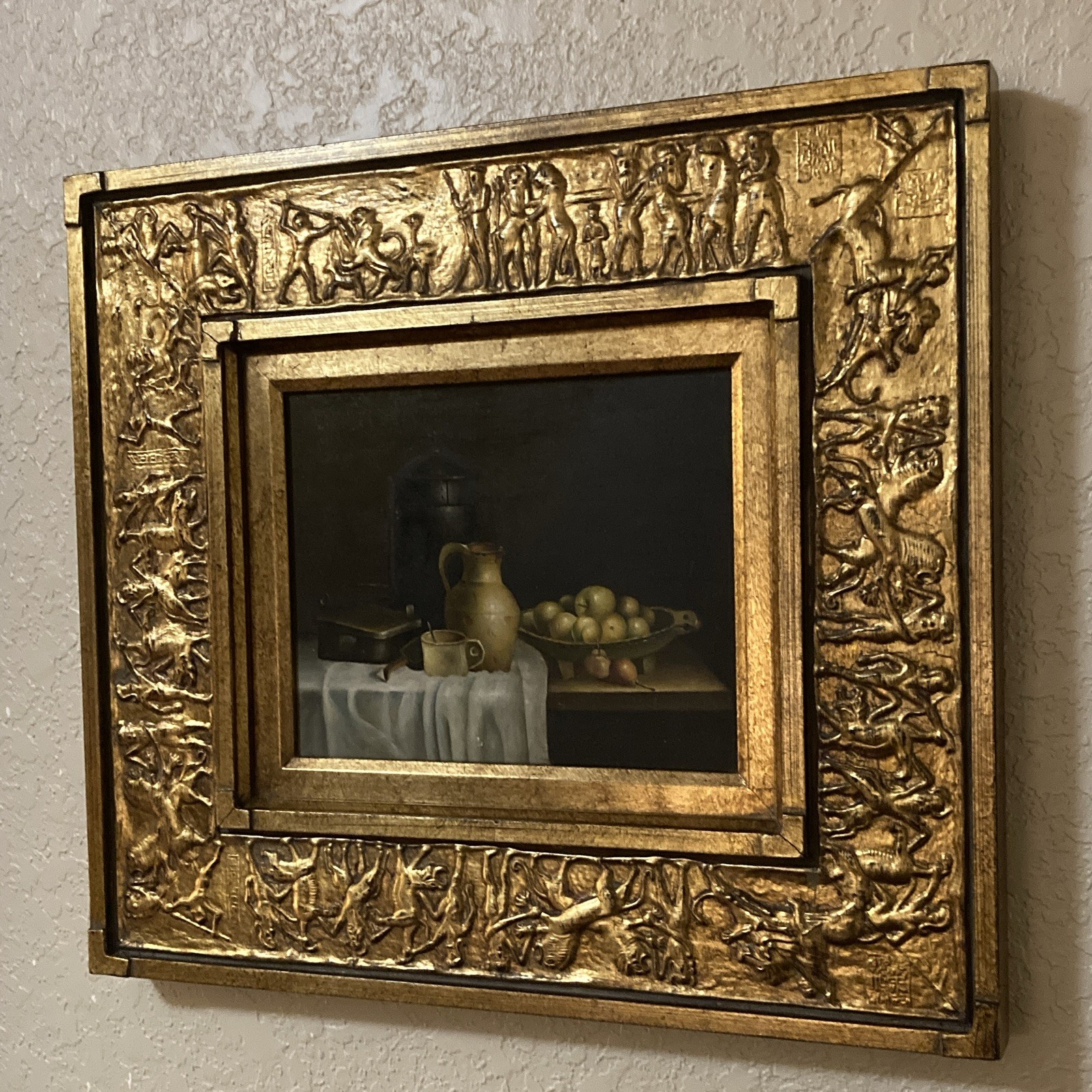 Still life oil painting of bowled fruit inside of textured ornate golden frame