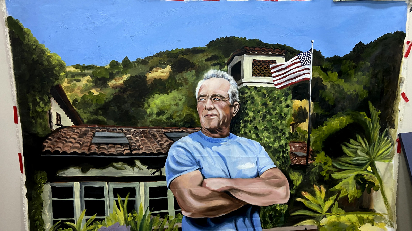 An oil painting of an old man in front of the American Flag