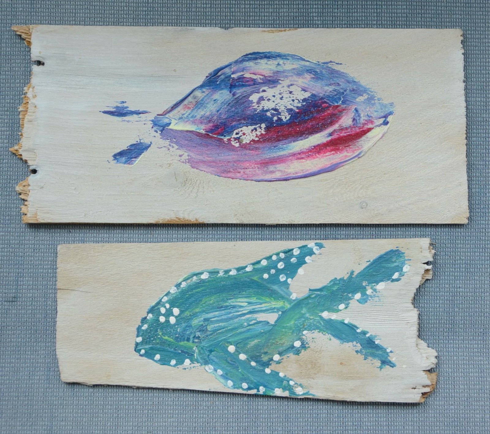 Two shingles from Cape Cod, Massachusetts that are painted with colorful fish!