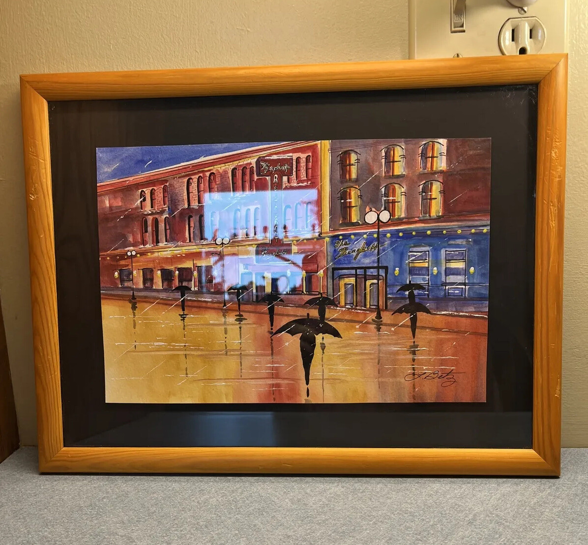Signed Primary Colorss Rainy Cityscape Framed Print by L. Betz 16″x12″