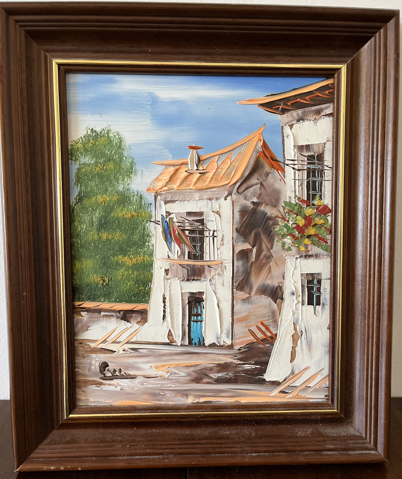 Painting of European Homes signed Ecco framed bright Art On Cork board 8 By 10