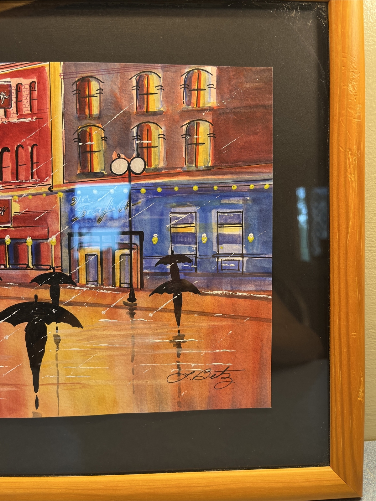 Signed Primary Colorss Rainy Cityscape Framed Print by L. Betz 16″x12″