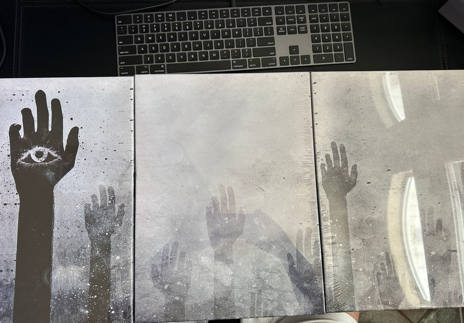 3 piece artwork Repeated raised hands in silhouette